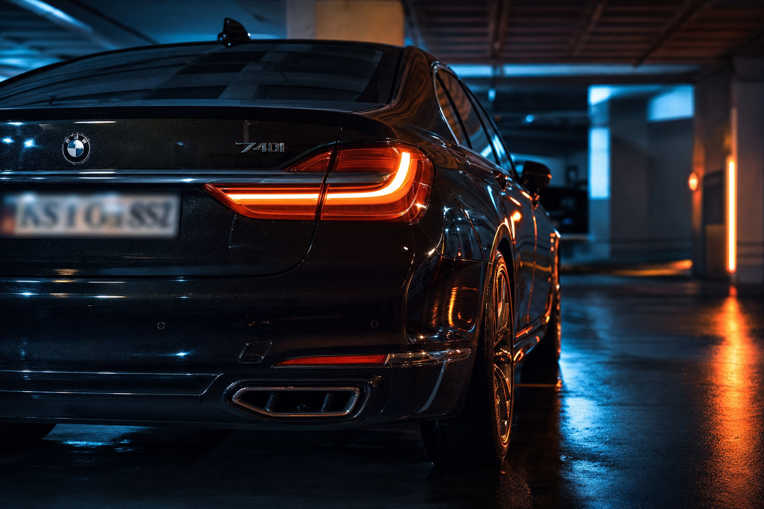 Sleek black sedan in moody parking garage